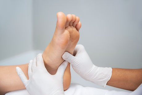 Medical professional examining a patient's foot — Oak Ridges Foot Clinic