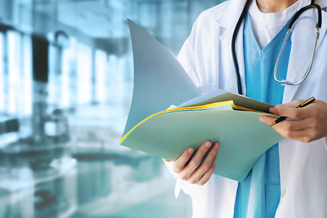 Doctor in white coat holding medical folder — Oak Ridges Medical and Urgent Care Centre